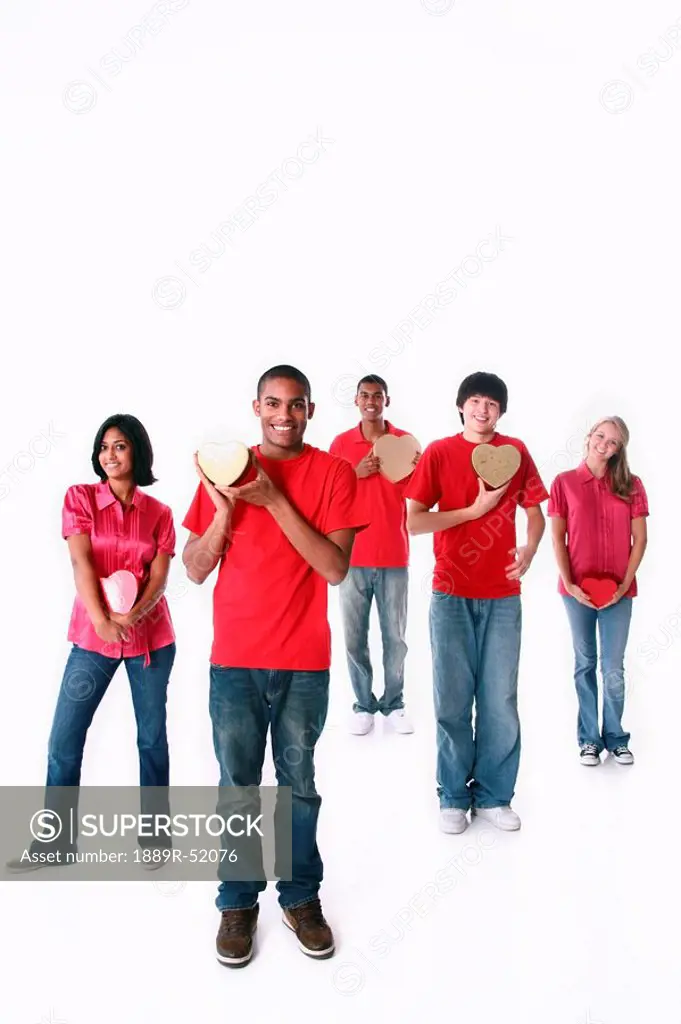 a group of teenagers holding hearts