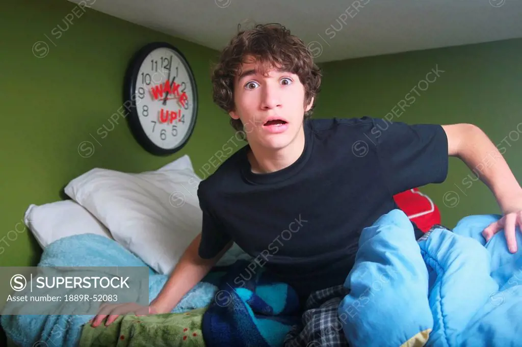 a teenage boy getting out of bed late