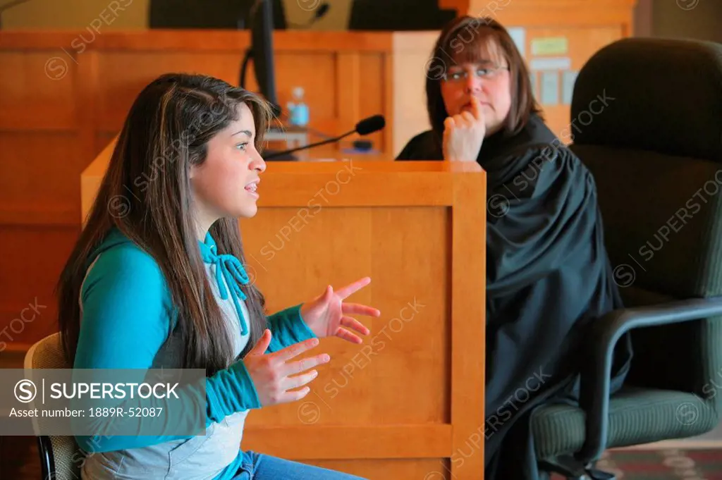 a teenage girl giving her testimony before a judge