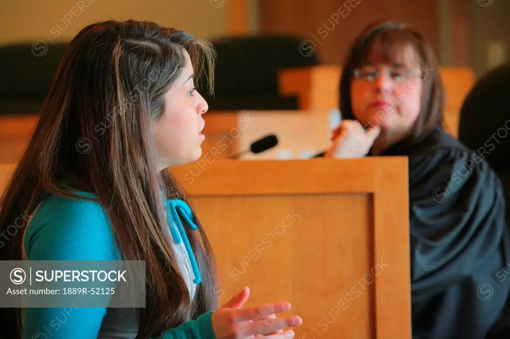 a girl talking to a judge