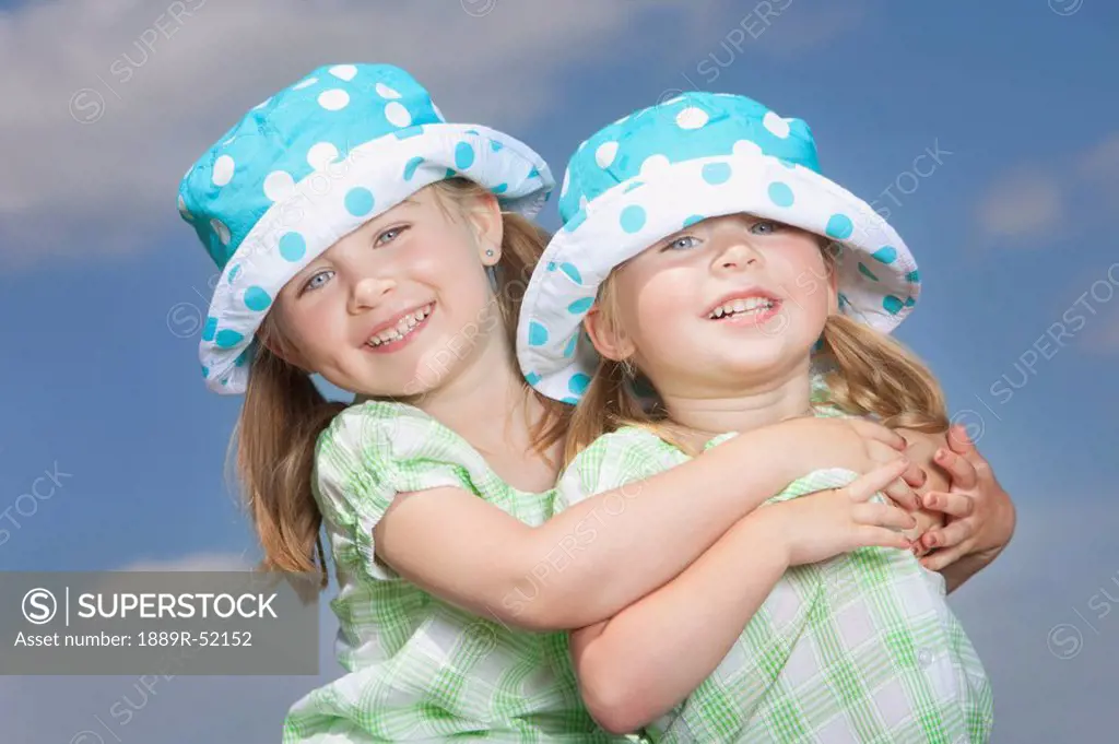two young girls in an embrace