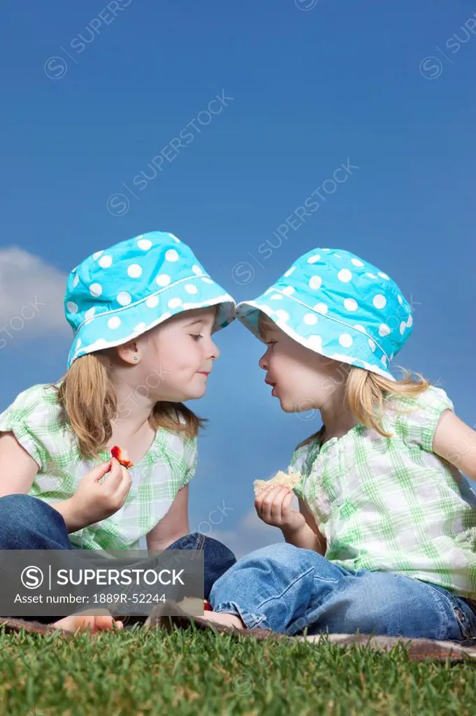 two young girls with matching hats