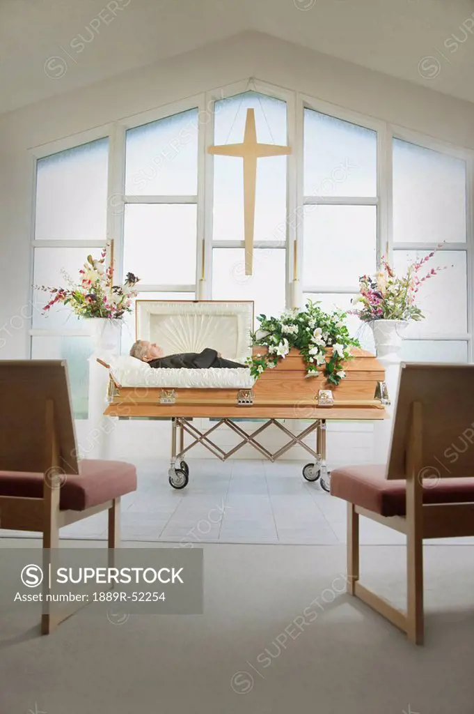 the deceased laying in a coffin at a funeral home