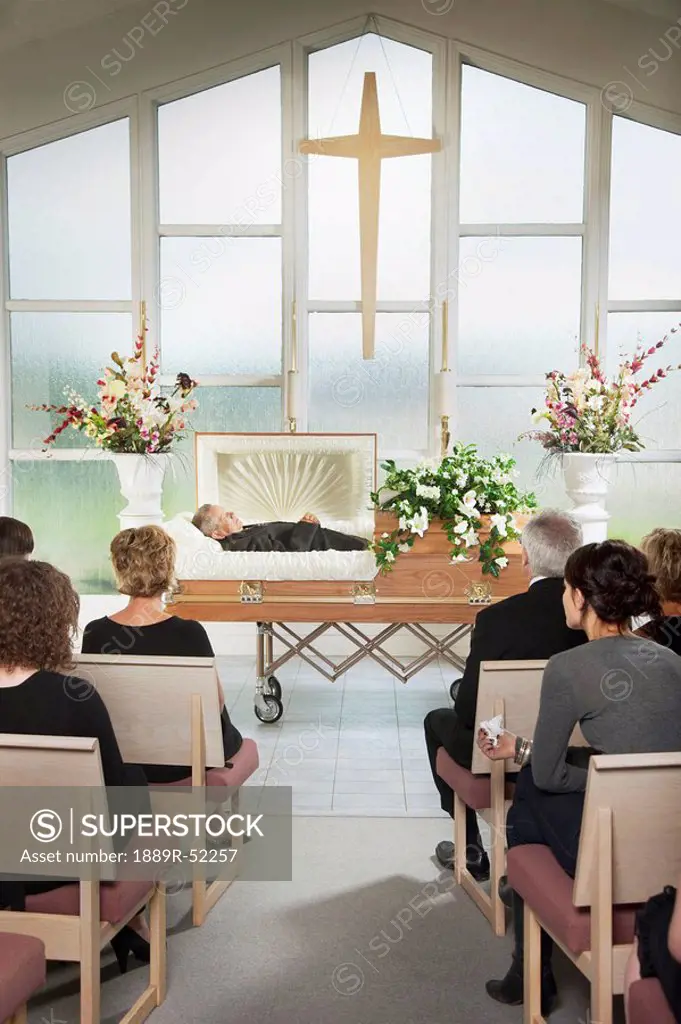 the deceased laying in a coffin at his funeral