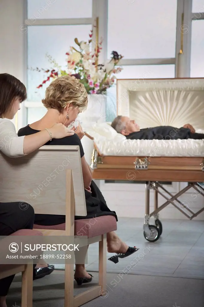 the deceased laying in a coffin at a funeral