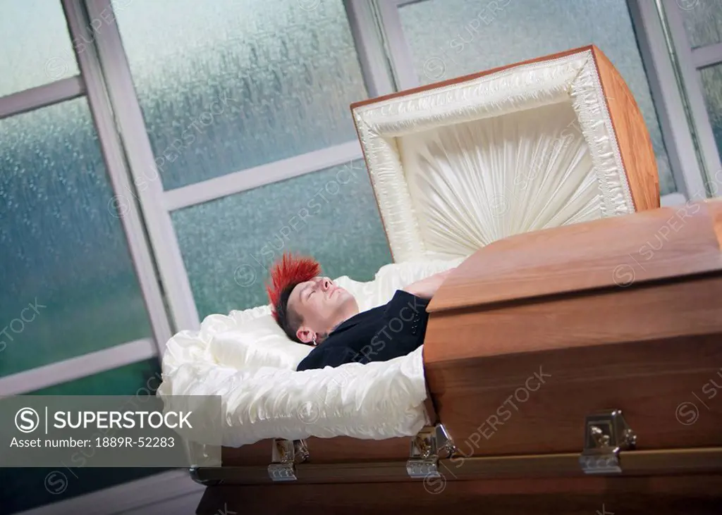 a deceased young man in a coffin