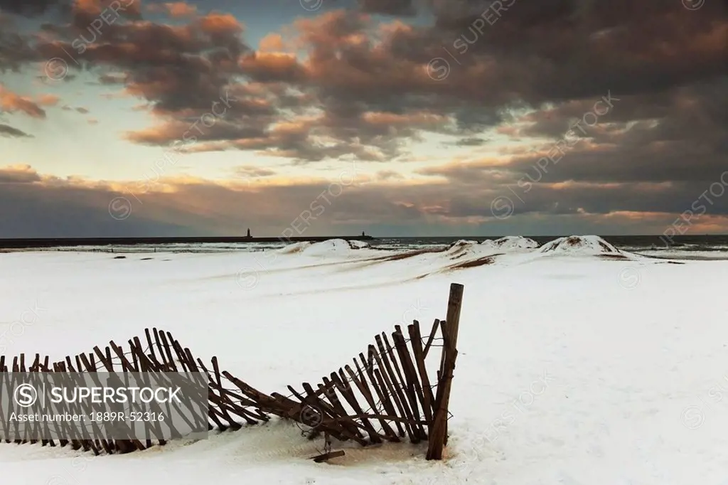 south shields, tyne and wear, england, a broken fence in a snow_covered field