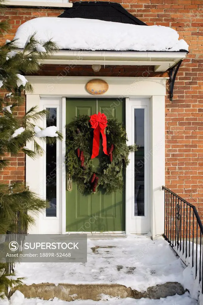 a wreath on the front door in winter