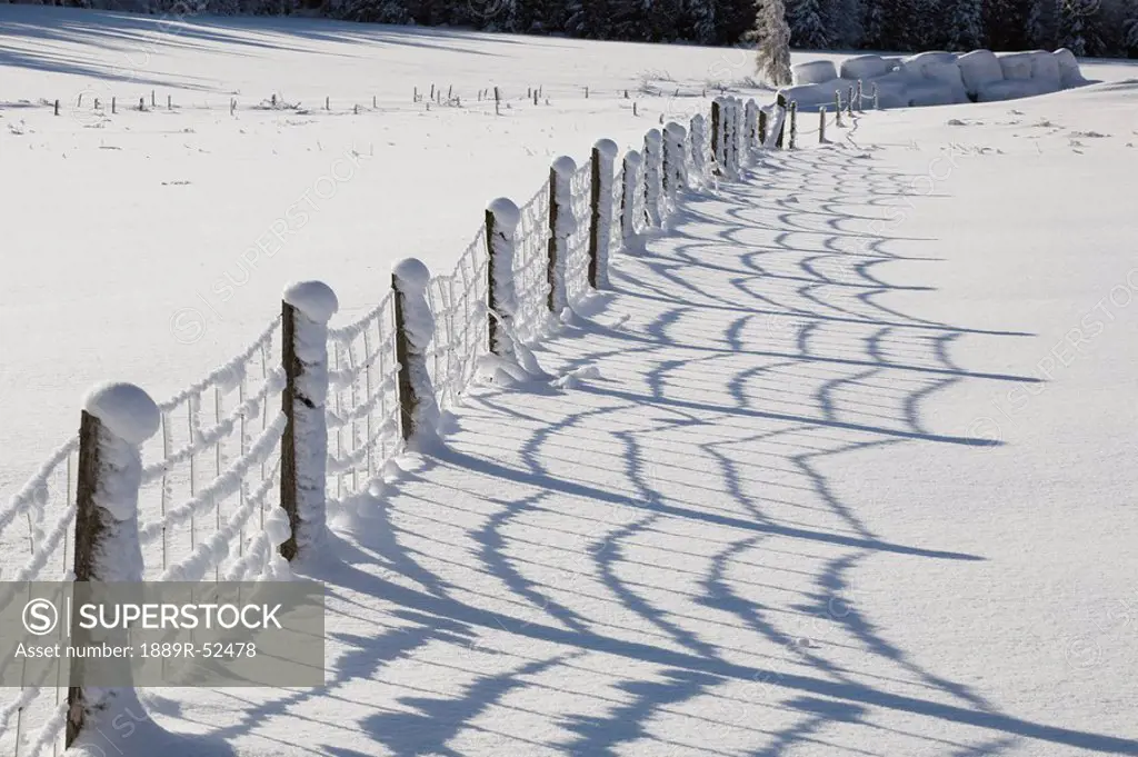 a field and fence covered in snow