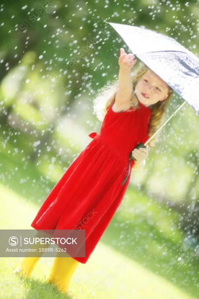 A little girl walking in the rain