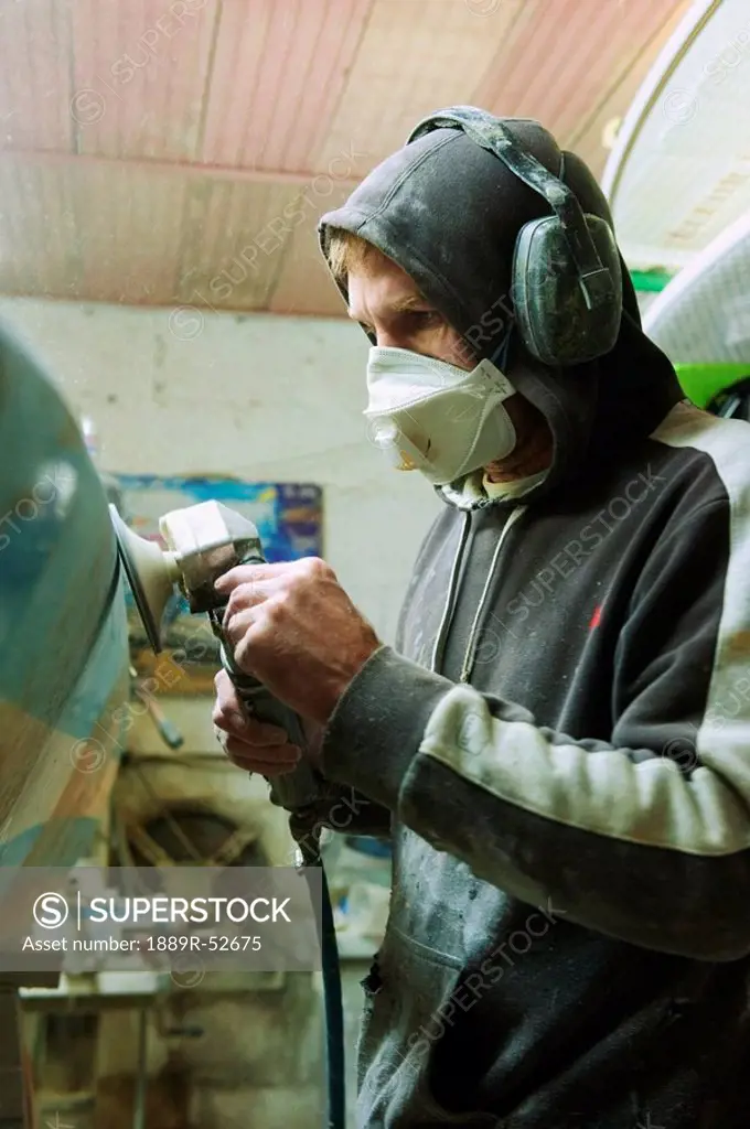 a man repairing a surfboard