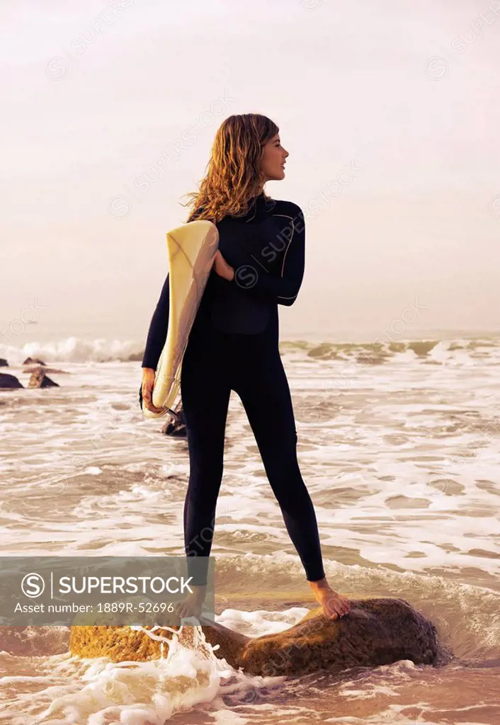young woman with her surfboard