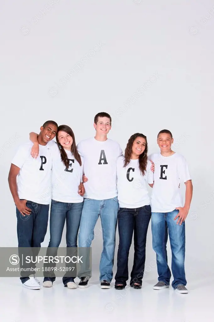 a group of teenagers wearing t_shirts with the message ´peace´