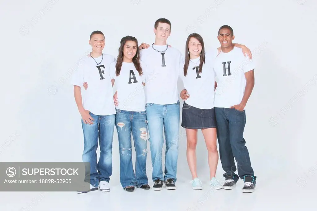 a group of teenagers wearing t_shirts with the message ´faith´