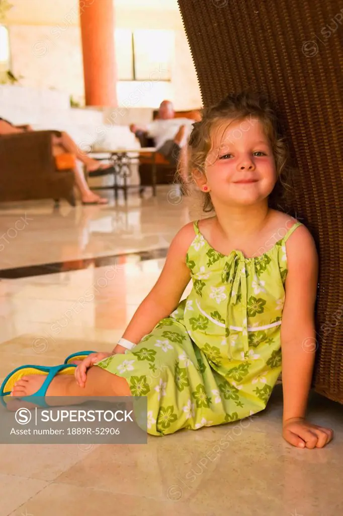akumal, mexico, a young girl sitting on the floor at a hotel