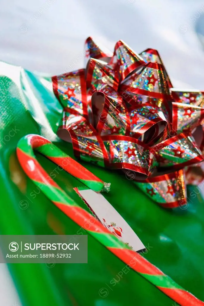 a bow and candy cane on a gift