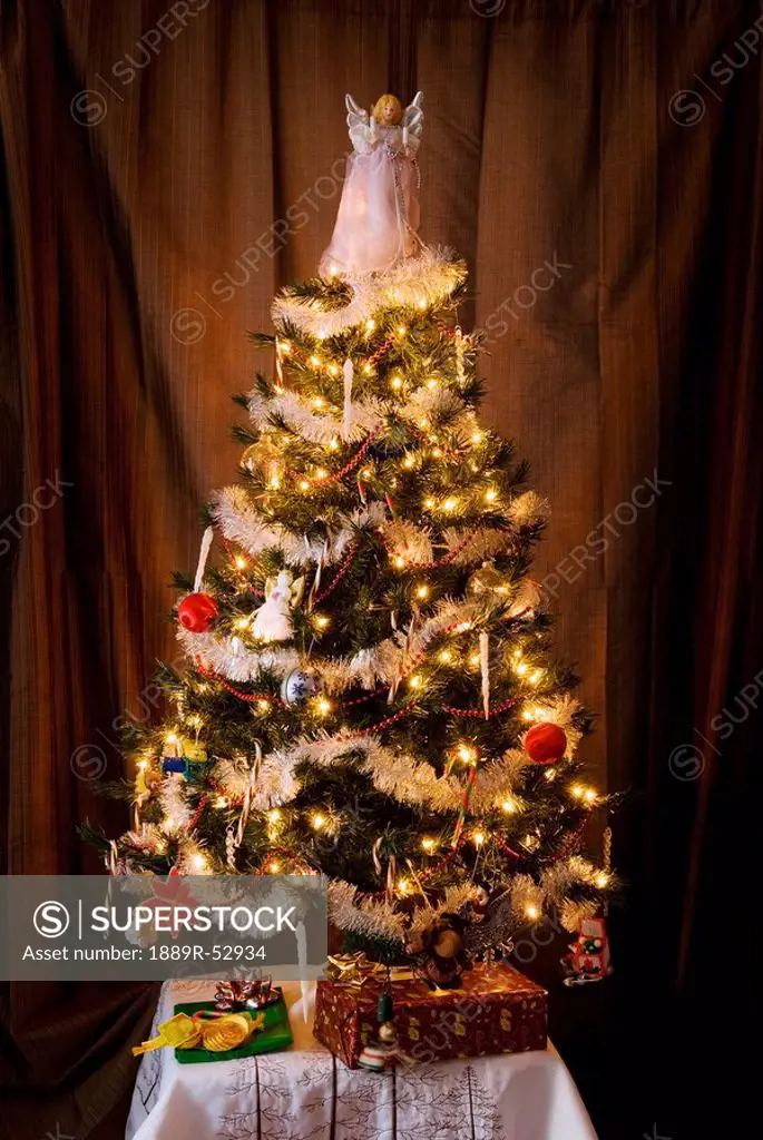 a decorated christmas tree with an angel on top