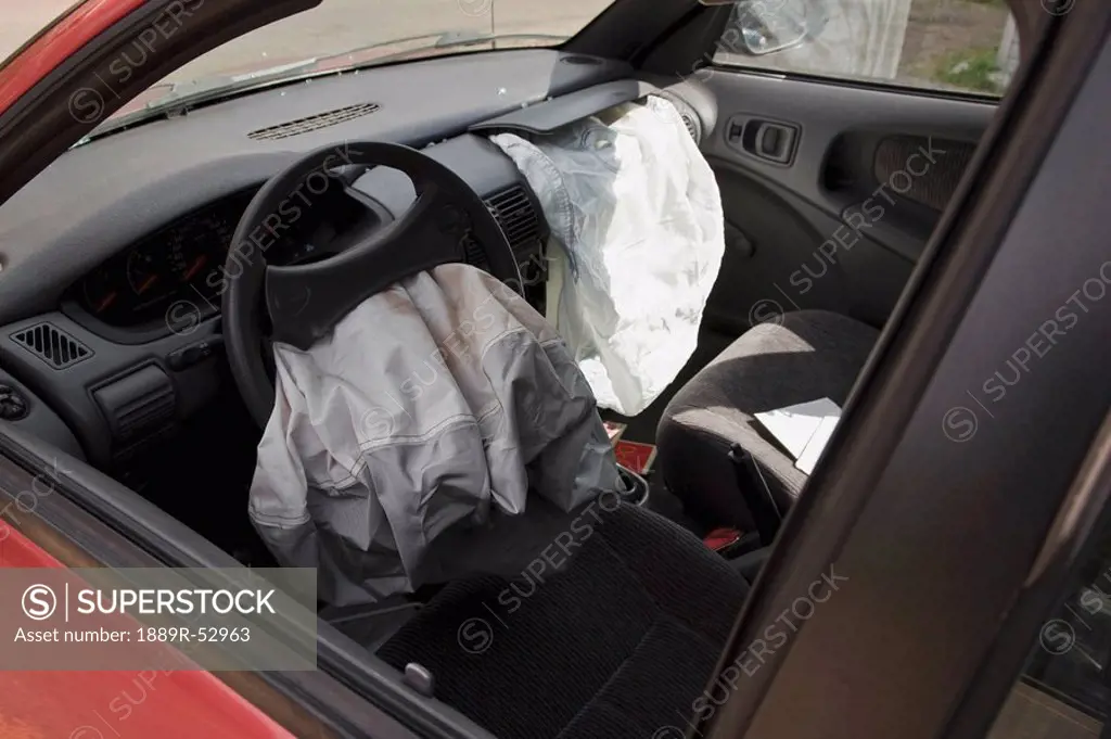 two air bags deflated in the front seat of a car