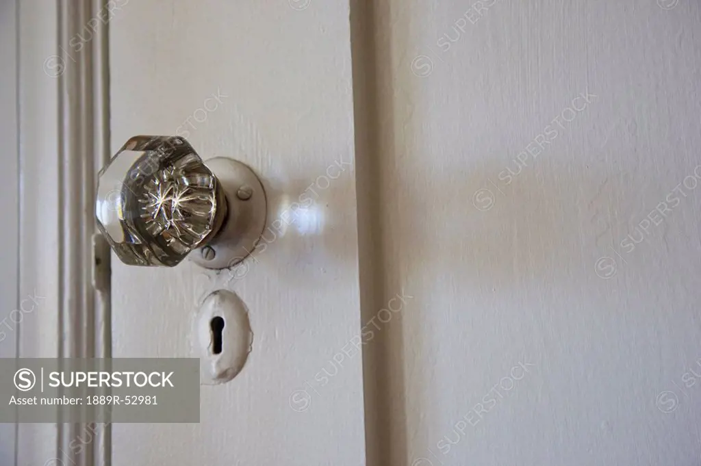 a crystal doorknob and keyhole on a white door