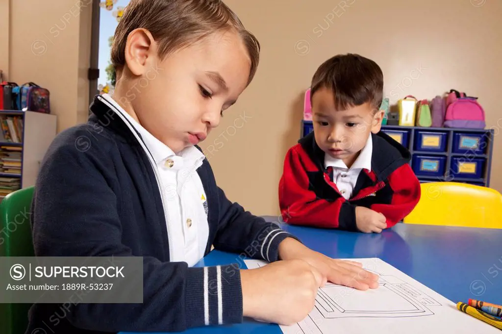 fort lauderdale, florida, united states of america,two young boys coloring at a table in a classroom