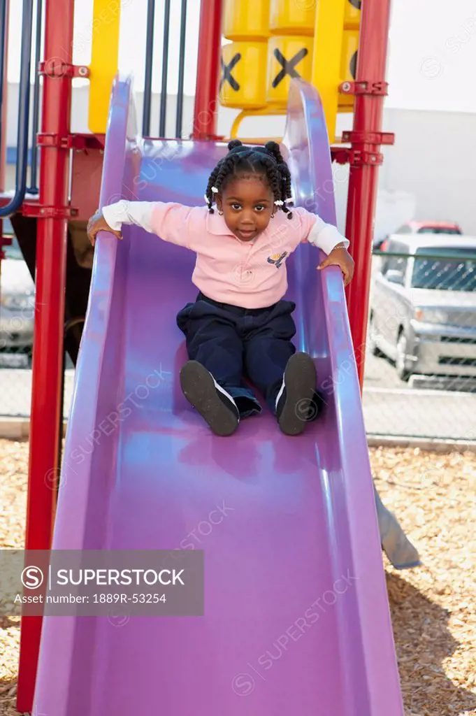 fort lauderdale, florida, united states of america, a young girl going down the slide at a playground