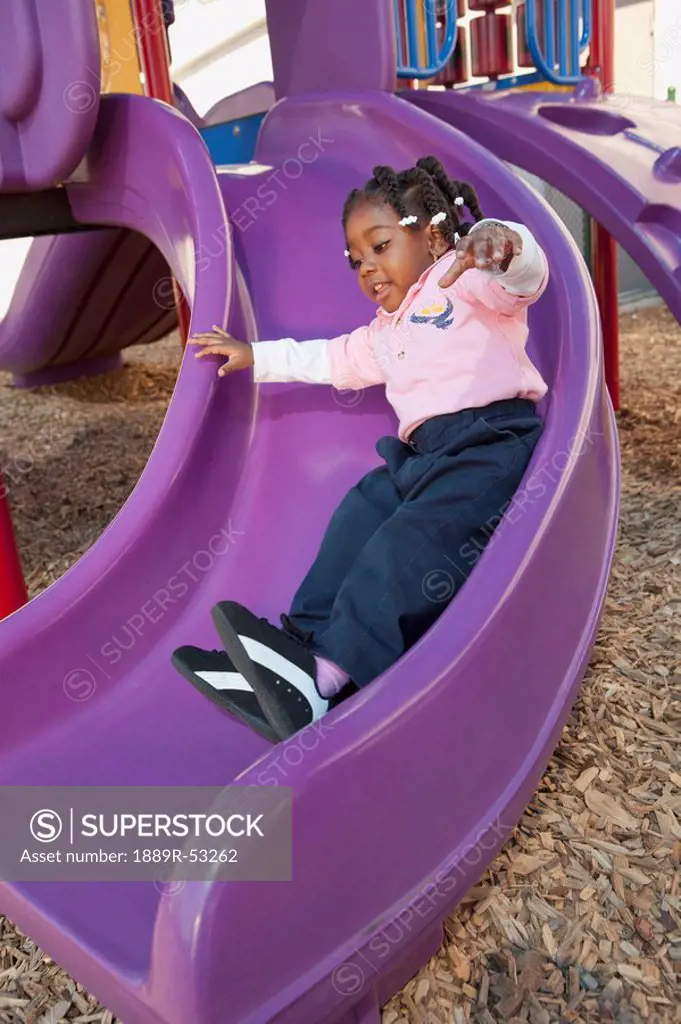 fort lauderdale, florida, united states of america, a young girl going down the slide at a playground