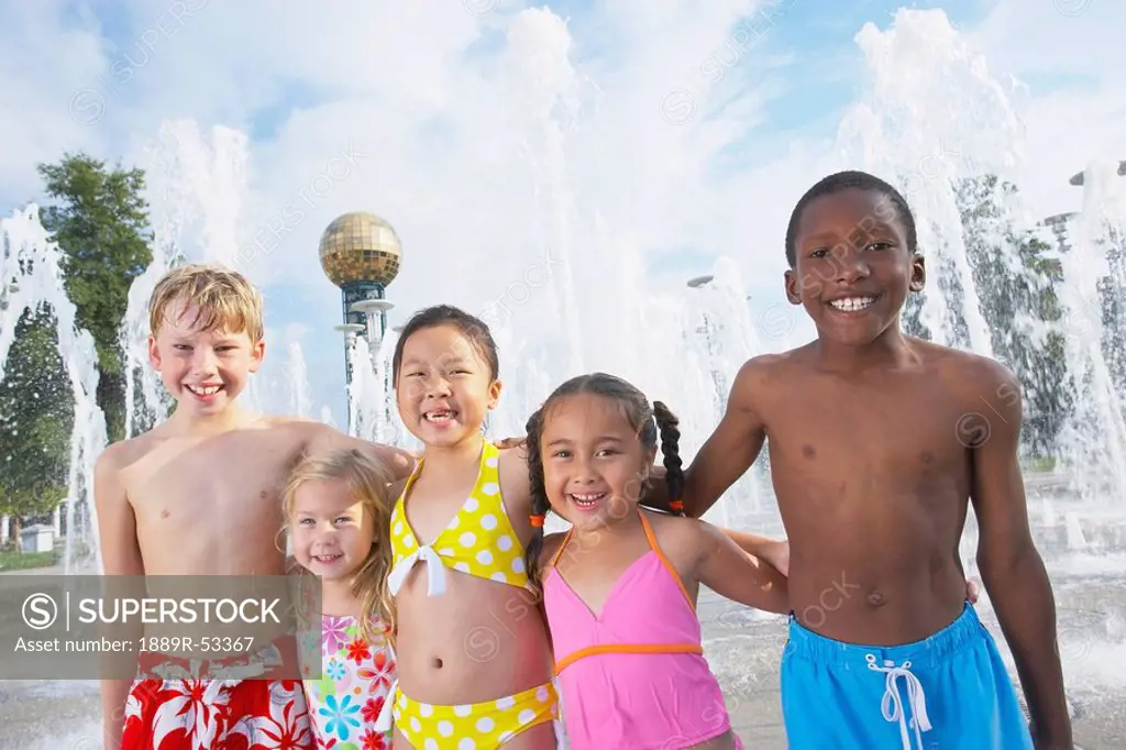 a group of children together at a water park
