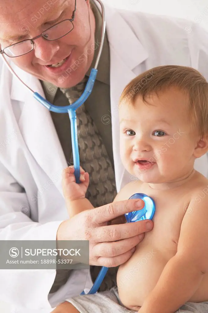 a pediatrician examining a baby