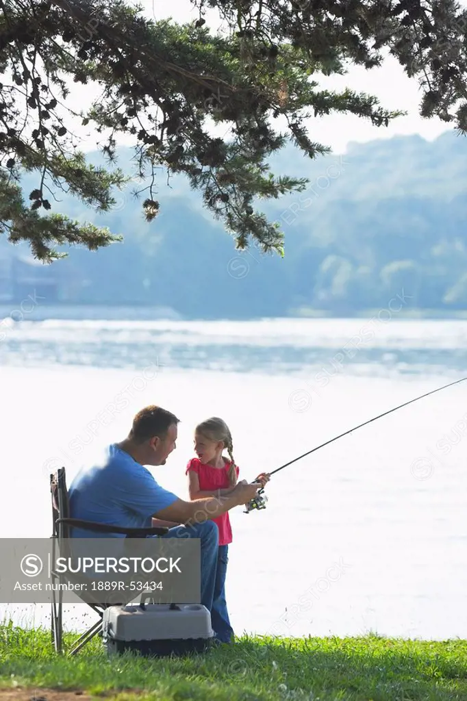 a father and daughter fishing together