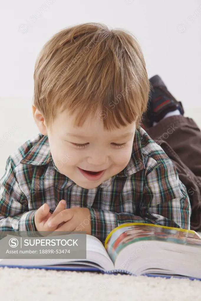 a young boy reading his bible