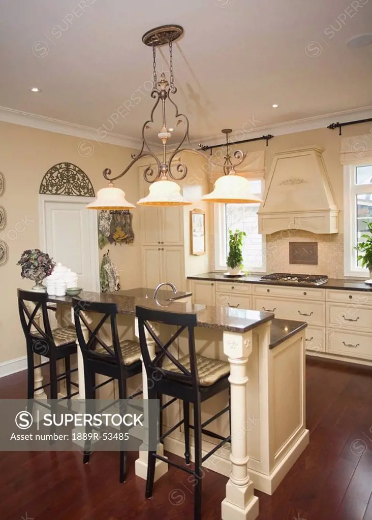 a kitchen island with chairs