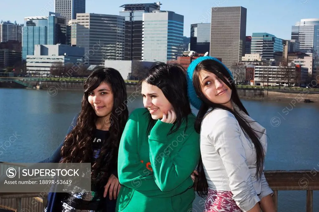 portland, oregon, united states of america, three teenage girls against the cityscape