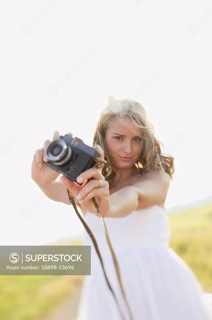 a bride holding a camera