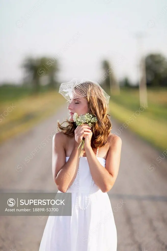 a bride standing in the middle of the road