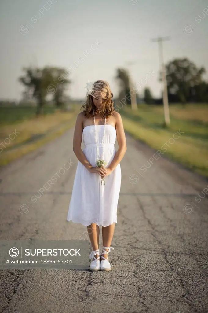 a bride standing in the middle of the road