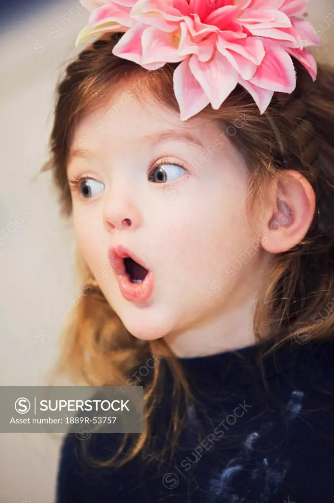 a young girl with a surprised look on her face