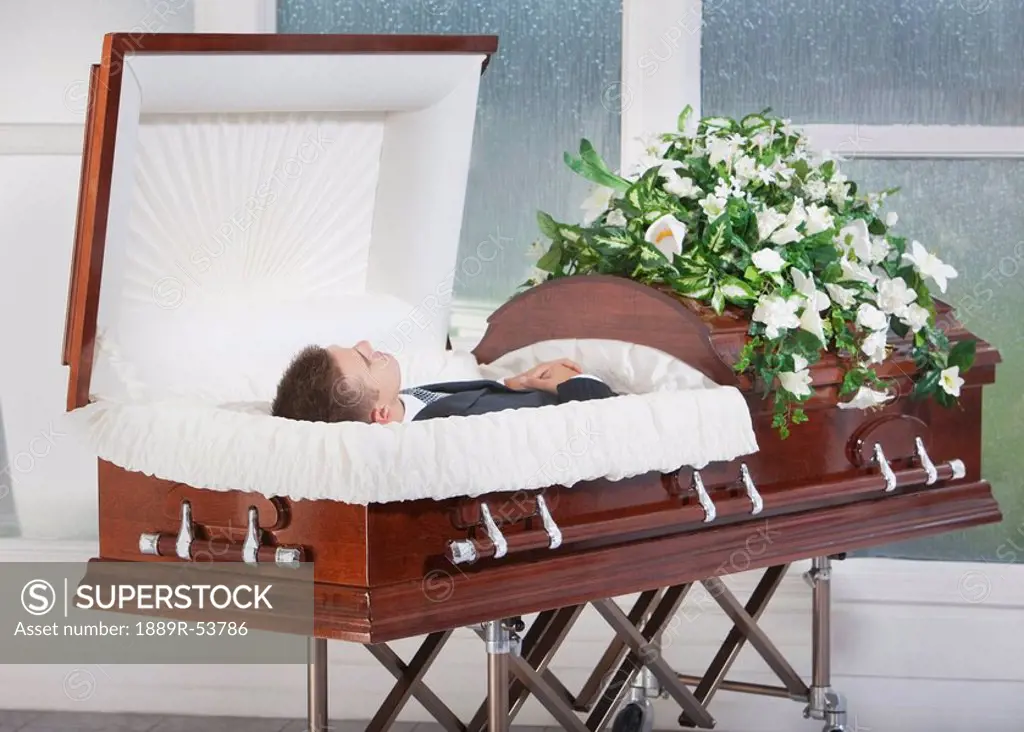 a deceased man laying in a coffin