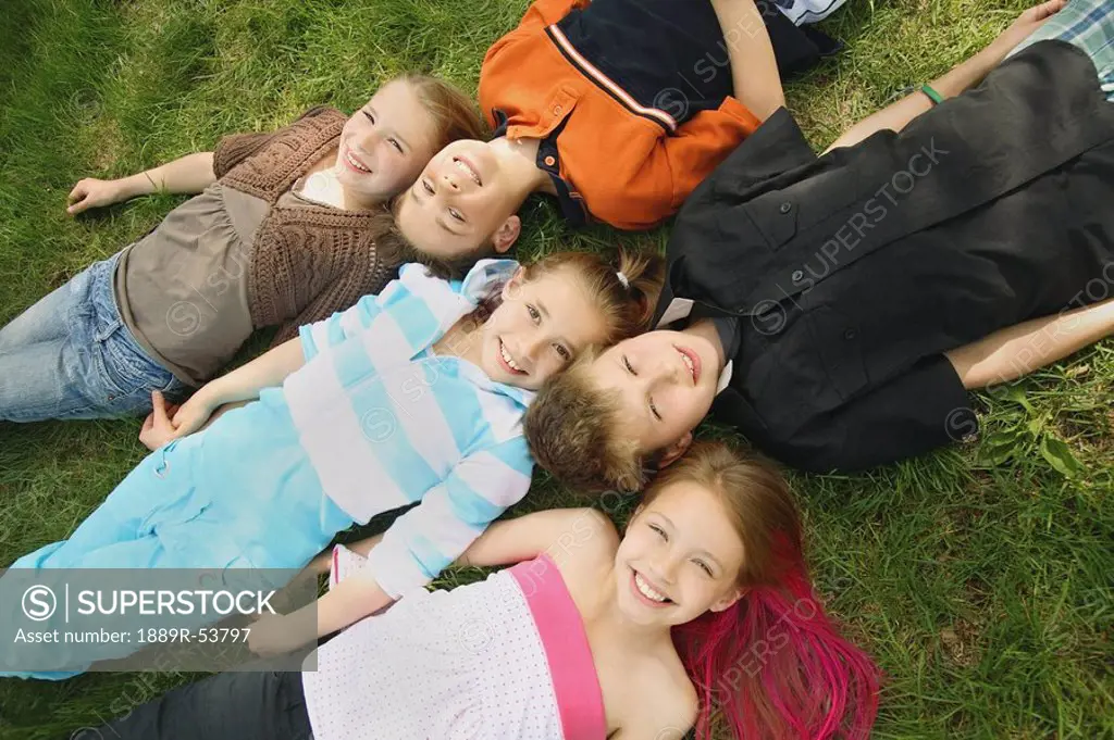 edmonton, alberta, canada, a group of children laying on the grass