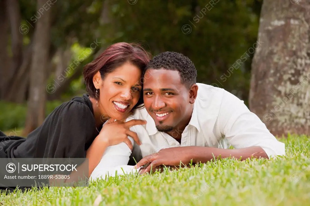 fort lauderdale, florida, united states of america, a couple laying on the grass in the park