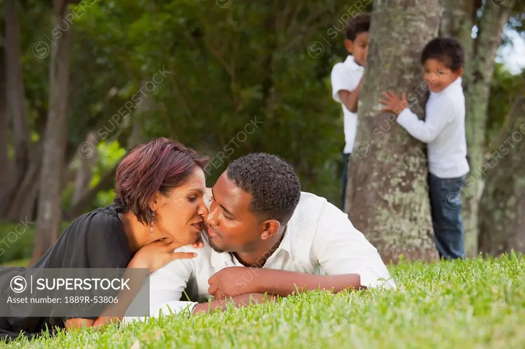 fort lauderdale, florida, united states of america, a couple kissing while their sons watch