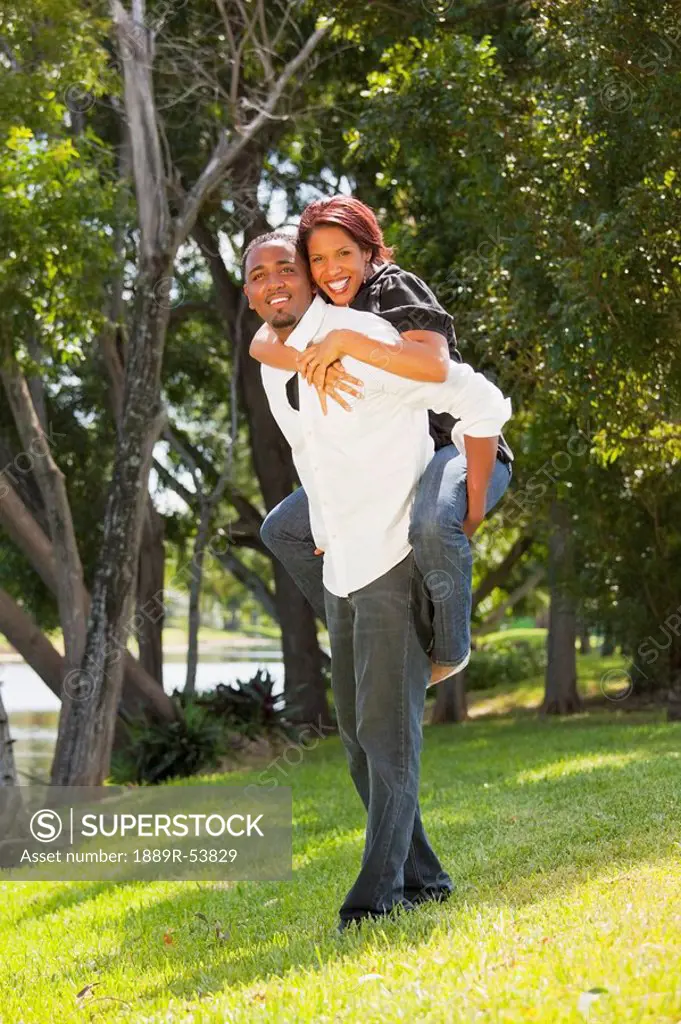 fort lauderdale, florida, united states of america, a man holding a woman on his back