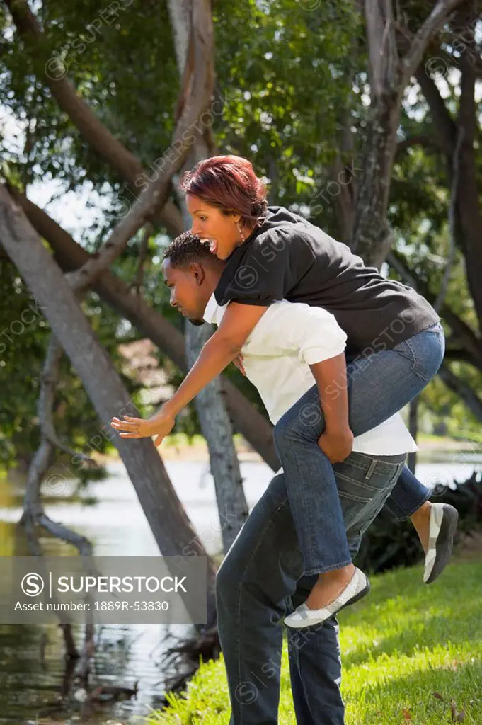 fort lauderdale, florida, united states of america, a man holding a woman on his back