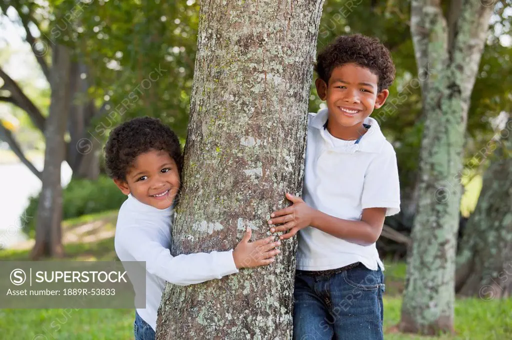 fort lauderdale, florida, united states of america, two boys standing by a tree