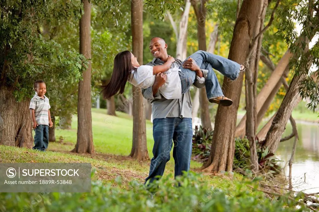 fort lauderdale, florida, united states of america, a couple having fun in a park while their young son watches