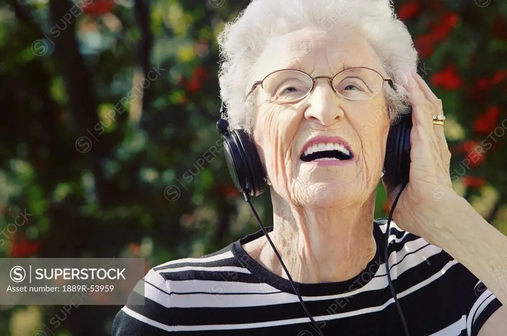 sherwood park, alberta, canada, a senior woman wearing headphones