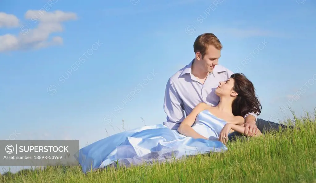 edmonton, alberta, canada, a man and woman laying on the grass together