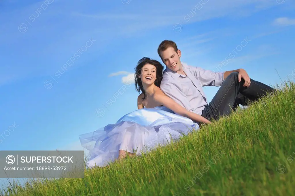 edmonton, alberta, canada, a couple sitting on the grass together