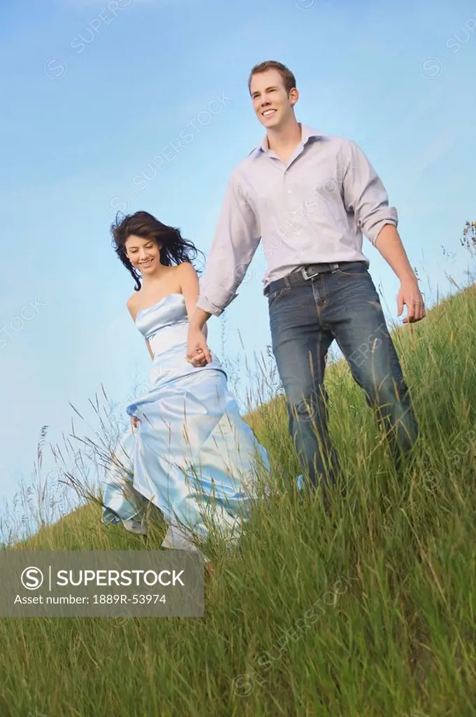 edmonton, alberta, canada, a couple running through the grass