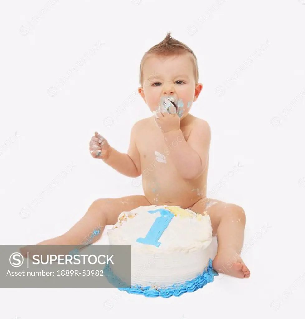 edmonton, alberta, canada, a baby eating a birthday cake with his hands