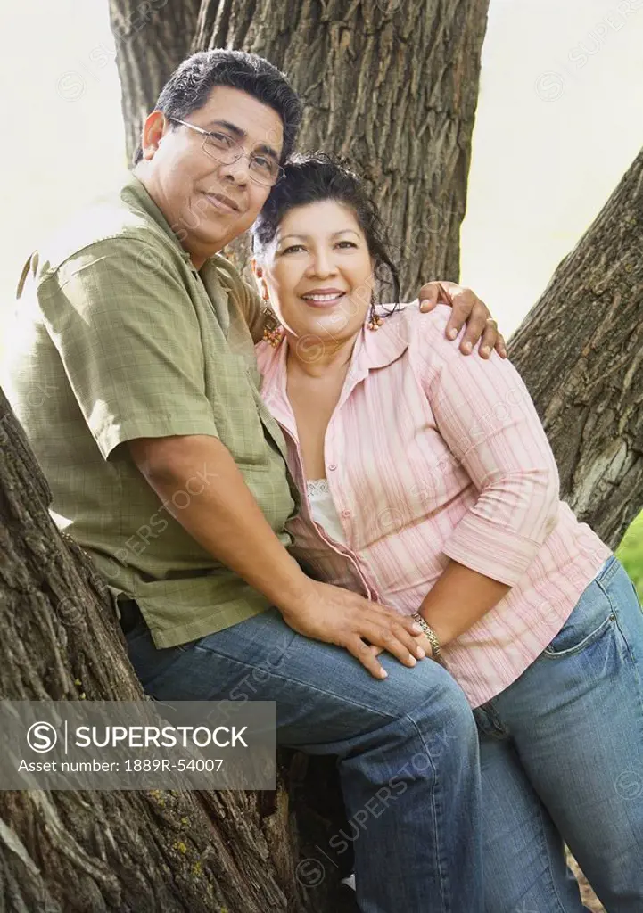 edmonton, alberta, canada, a man and woman leaning against a tree
